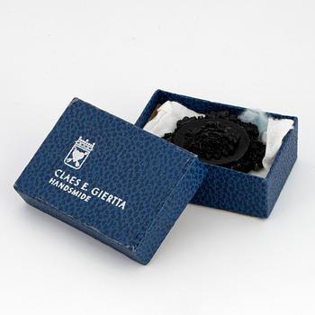 Carved possibly jet/coal and silver brooch.