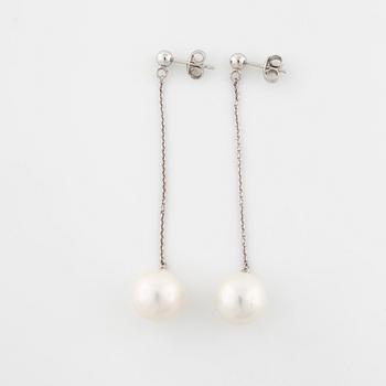 A pair of cultured pearl earrings.