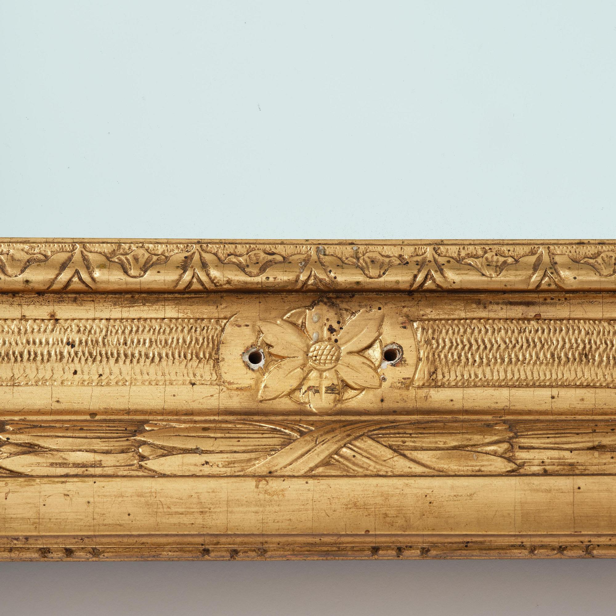 A Gustavian giltwood frame with mirror glass, late 18th century.