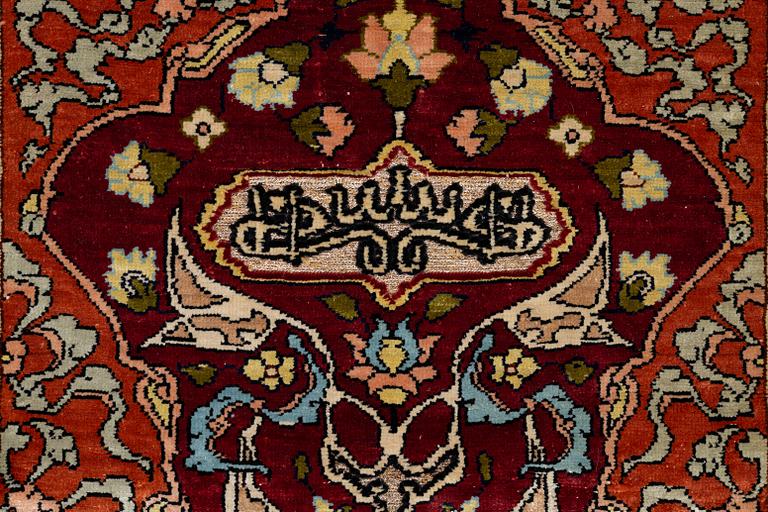 A silk and metal Hereke rug, West Anatolia, c. 58 x 39 cm.