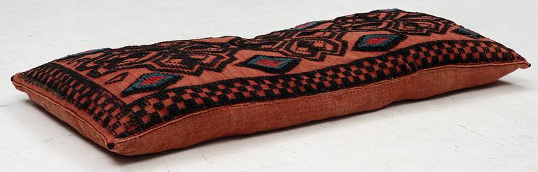 A carriage cushion, knotted pile in relief, ca 106 x 47, southwest of Scania, Sweden, circa 1800.