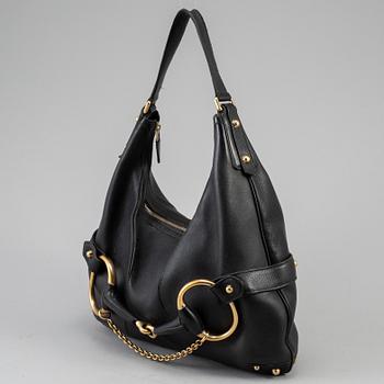 GUCCI, a leather horse-bit bag.