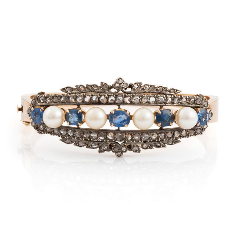 An 18K gold bracelet set with cultured pearls, faceted sapphires and rose-cut diamonds.