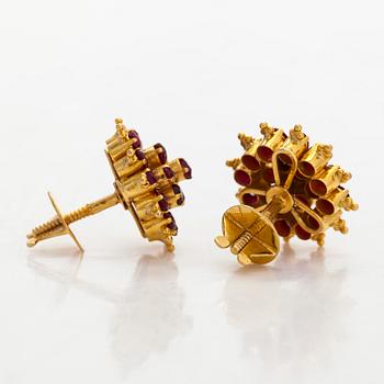 A pair of 18K gold earrings and rubies.