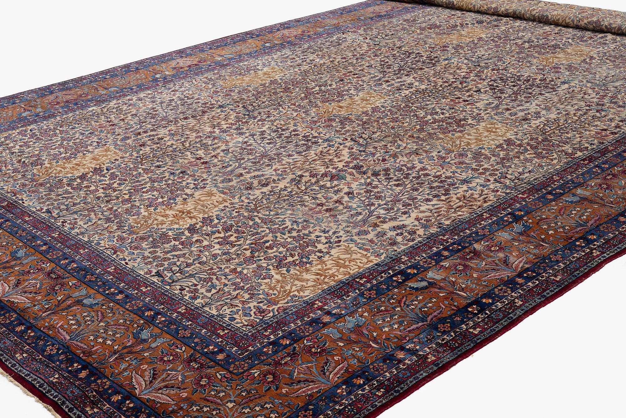 An antique 'Millefleur' Kerman Laver carpet, c. 964 x 426 cm.