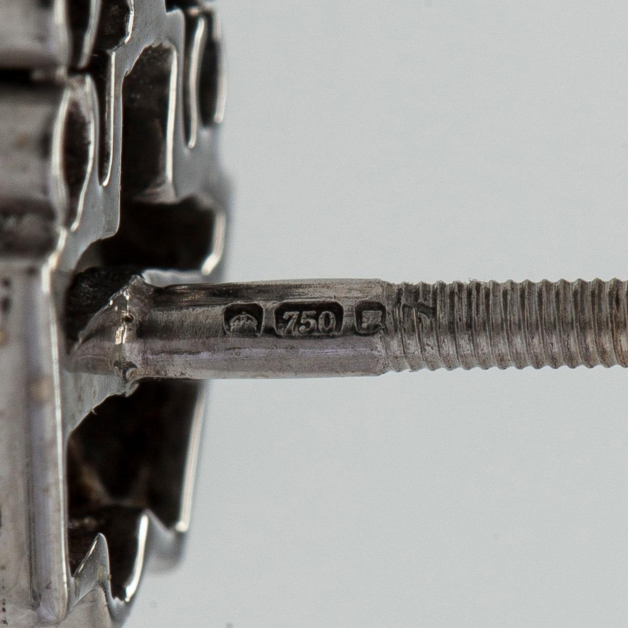 A pair of 18K white gold earrings set with baguette-cut and brilliant-cut diamonds.