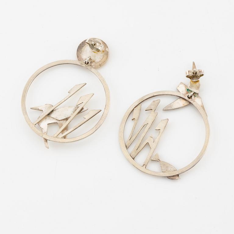 A pair of earrings featuring birds and fish, silver with gold detail.