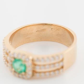 An emerald and brilliant cut diamond ring.