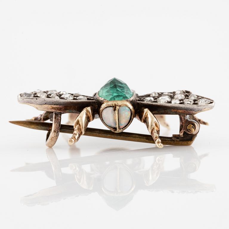 A brooch in silver and 14K gold with coloured gemstones and rose-cut diamonds.