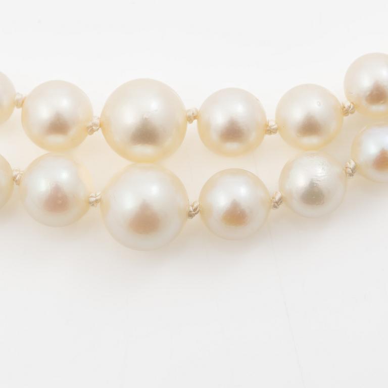 Double-row necklace with graduated cultured pearls, silver clasp set with paste stones.