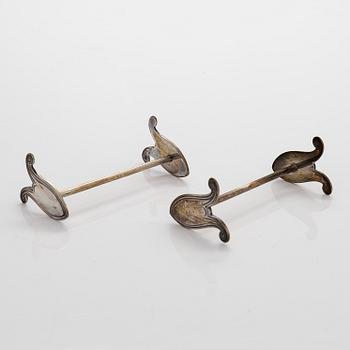 A salt cellar, paper knife, dish, and 12 butter knife stands, Art Nouveau, early 20th century. Two marked WMF.