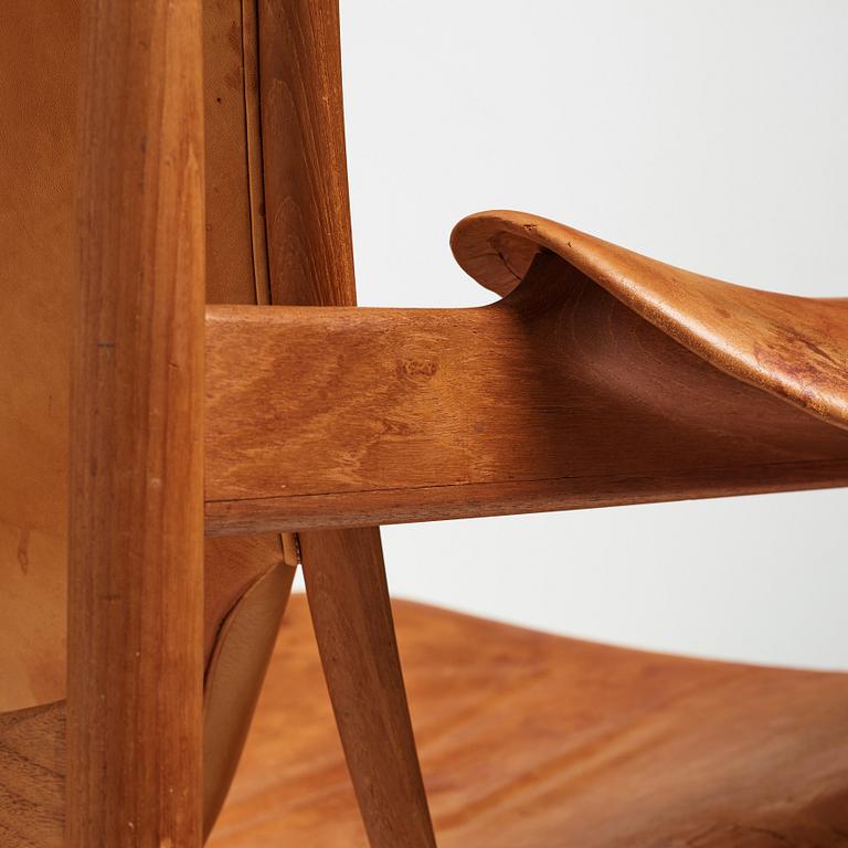 Finn Juhl, a teak and natural brown leather "Chieftain Chair" by Niels Vodder, 1950-60's.