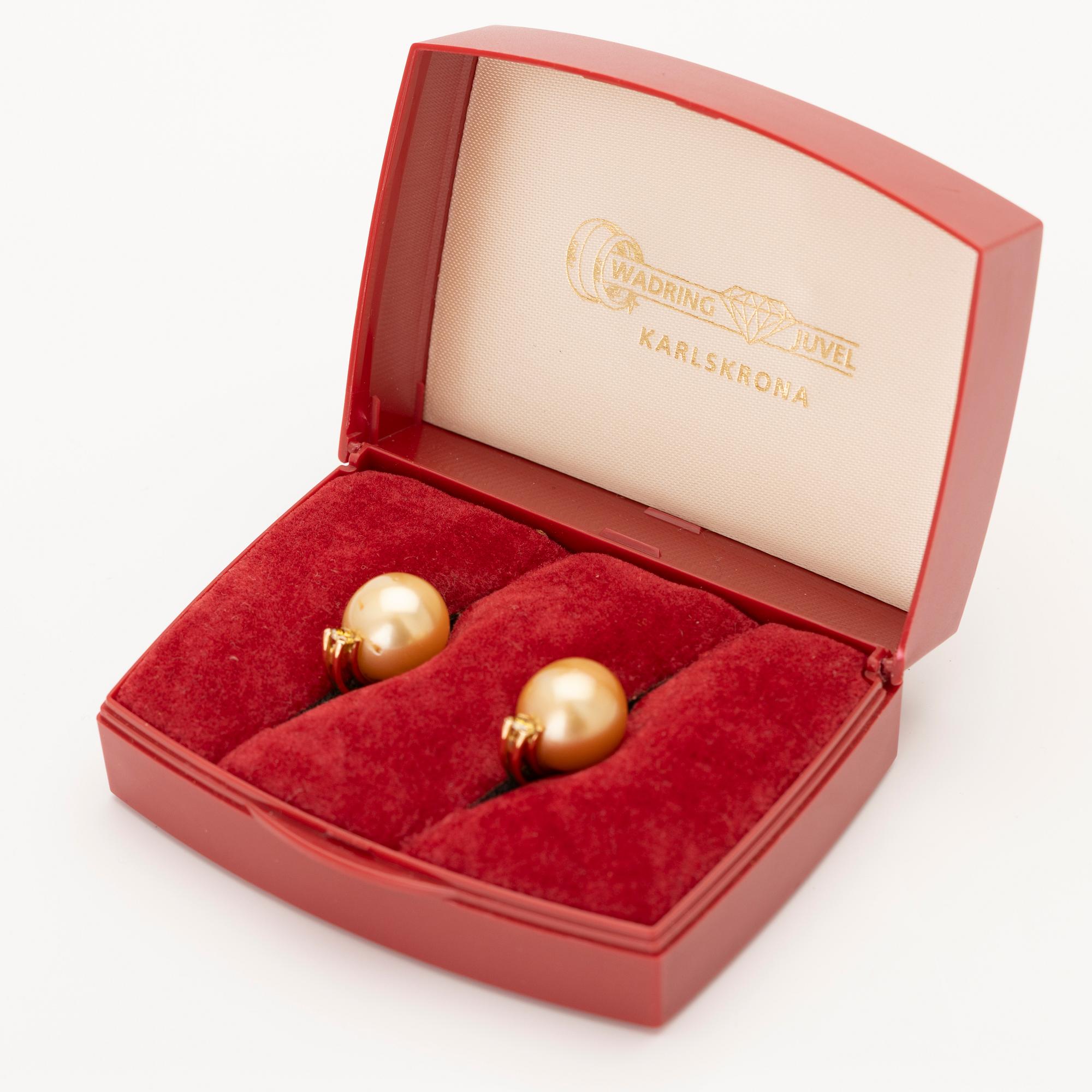 18K gold earrings with South Sea pearls and diamonds.