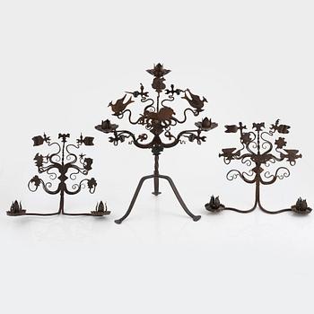 A wrought iron candelabra and a pair of wall sconces, Italy, mid/second half of the 20th century.