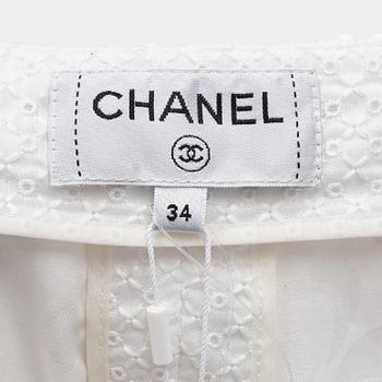 Chanel, a pair of broderie anglais trousers with pearls, size 34.