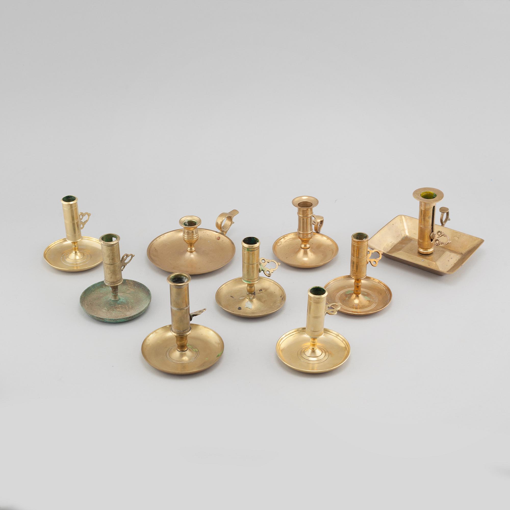 Nine brass candlesticks, 20th century.