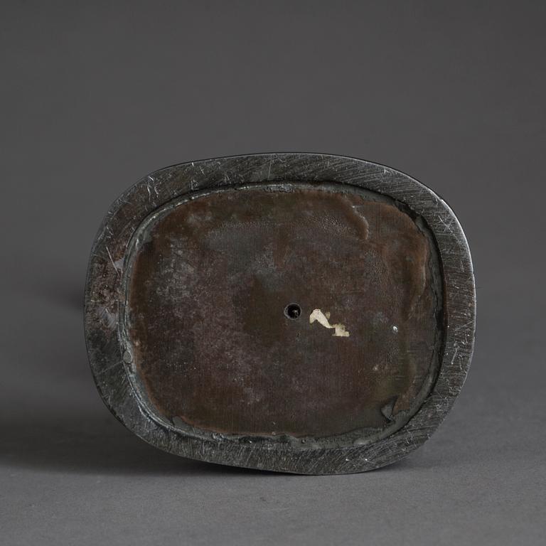 JUST ANDERSEN, a signed metal sculpture.