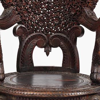 A pair of carved 'blackwood' armchairs, Bombay presidency, British Raj, circa 1880.