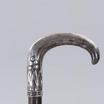 A CANE WITH SILVER MOUNTING, 1910.