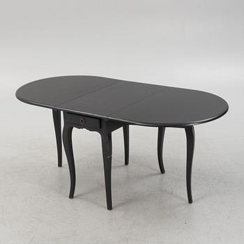 A contemporary painted drop-leaf table.