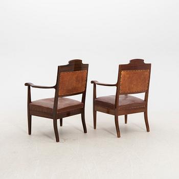 A pair of early 1900s armchairs.