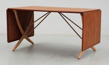 A Hans J Wegner teak and beech dinner table by Andreas Tuck, Denmark.