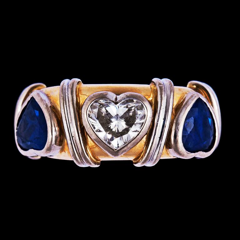 A heart cut diamond and blue sapphire ring.