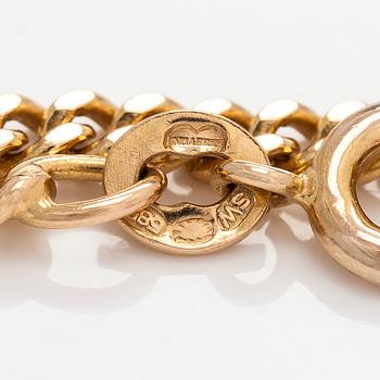 Kaulakoru, 14K ja 18K kultaa, tupsuriipuksella. Sveitsi ja Italia.