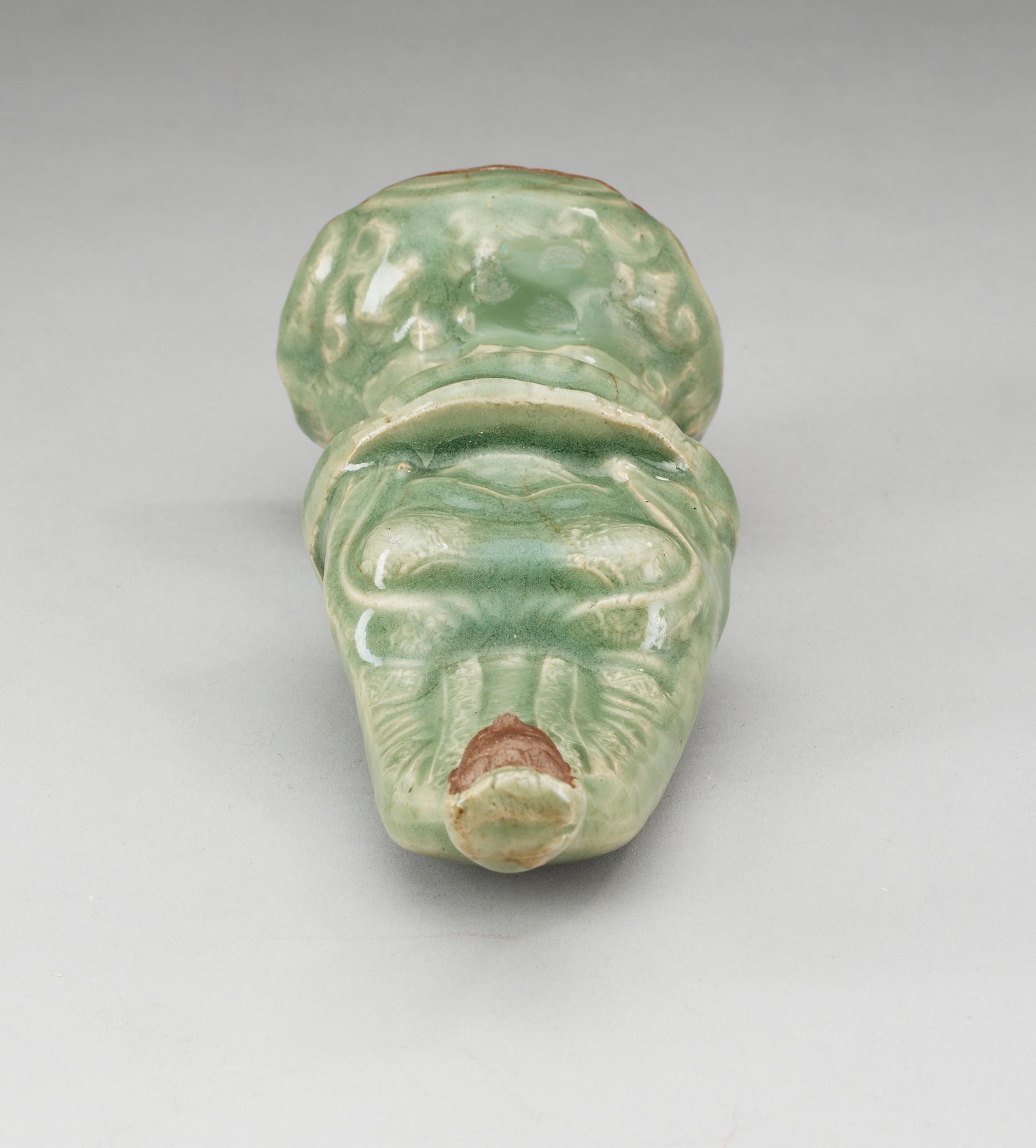 A celadon glazed figure of Guanyin, Ming dynasty.