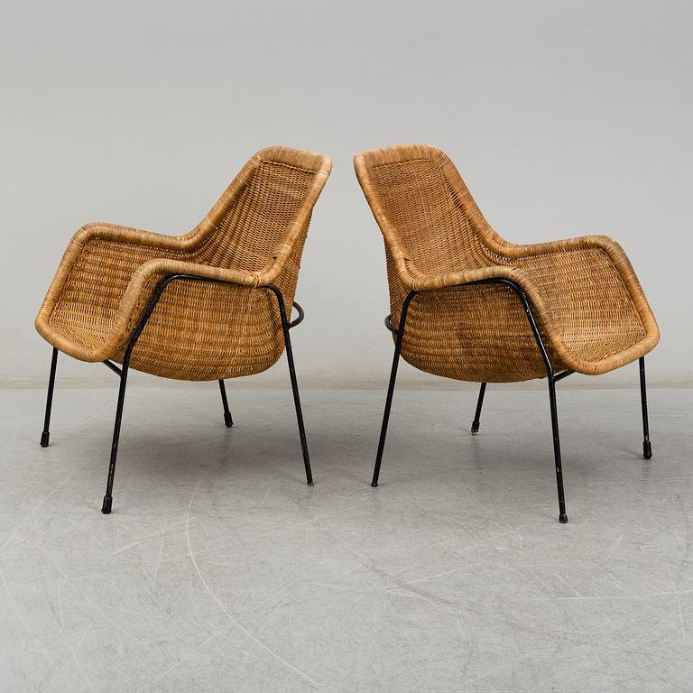 A 1950's pair of rattan easy chairs.