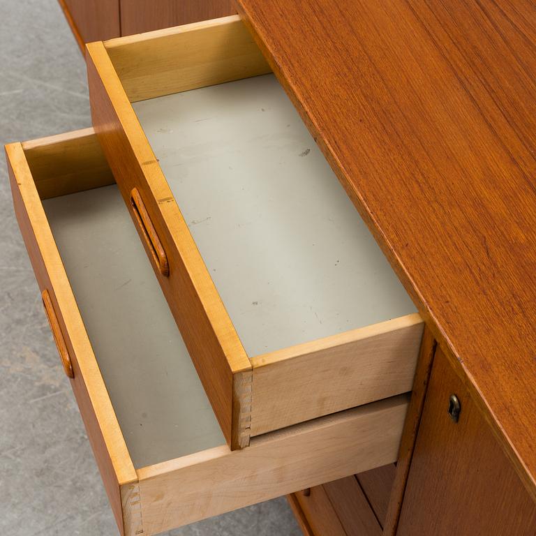 A 1960's teak vaneered sideboard.