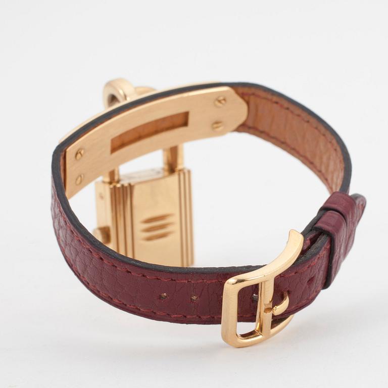 HERMÈS, a burgundy red leather braclet with 14k gold plated watch, "Kelly Lock".