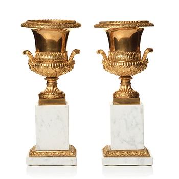 137. A pair of French 19th century gilded urns.