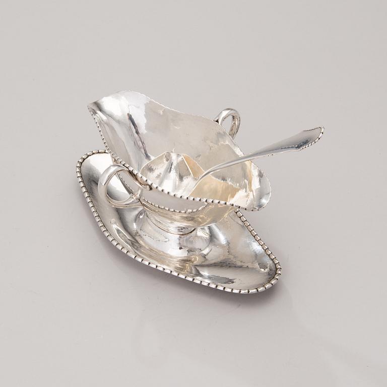 A sauce boat with a sauce ladle in silver, mark of Paul Bang, Copenhagen, Denmark 1929 and 1930s.