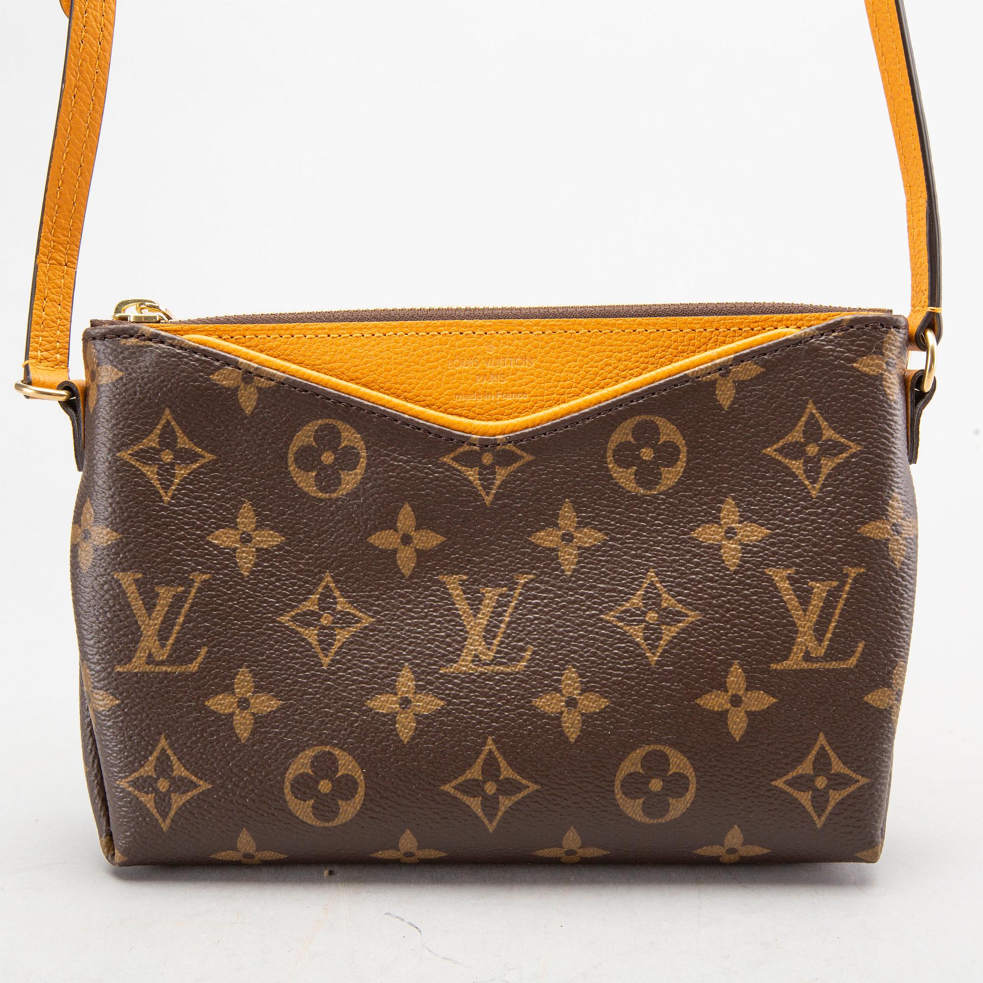 A Louis Vuitton Pallas clutch.