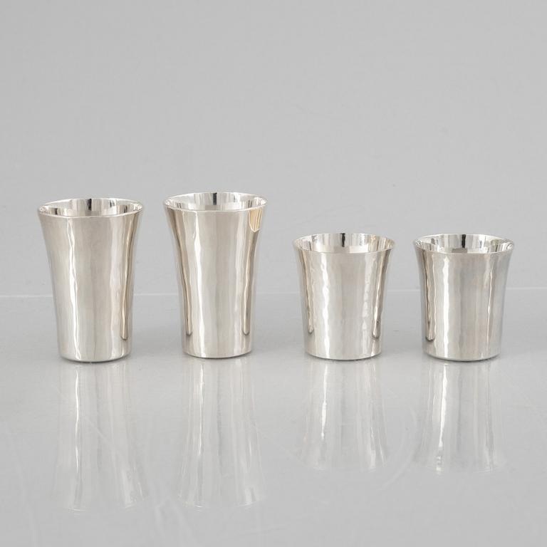 Eric Löfman, a Swedish silver candlestick, a vase and four cups, including MGAB, Uppsala 1977.
