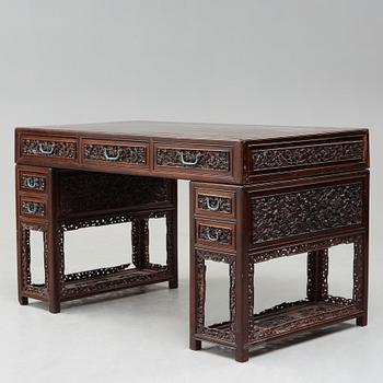 A carved hardwood desk, late Qing dynasty, circa 1900.