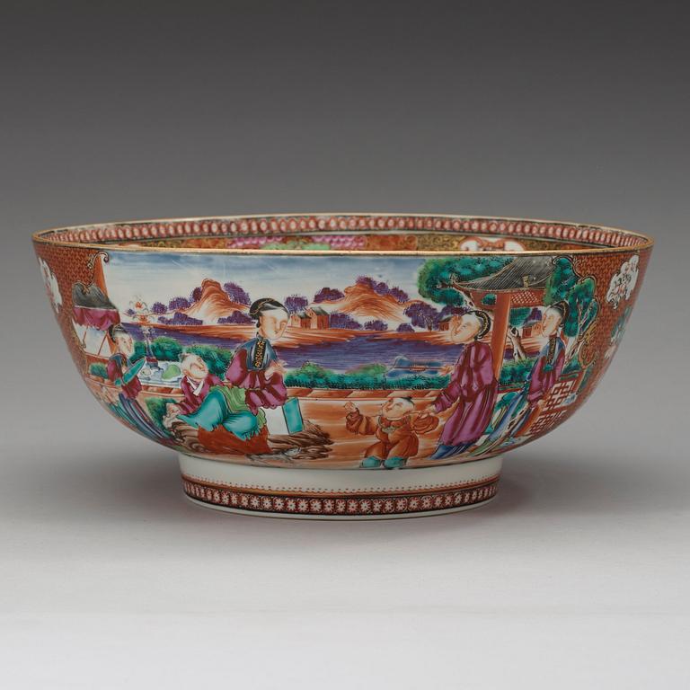 A large famille rose punch bowl, richly decorated with palace scenes, Qing dynasty, 18th century.
