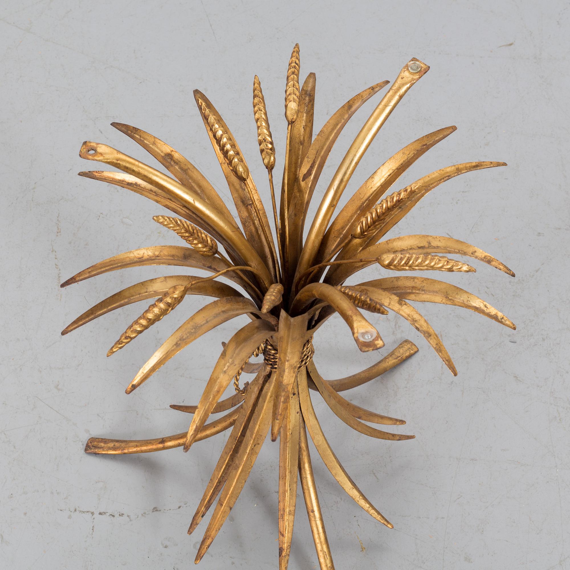 A HANS KÖGL ROUND GLAS AND GUILT METAL SMALL COFFEE TABLE.