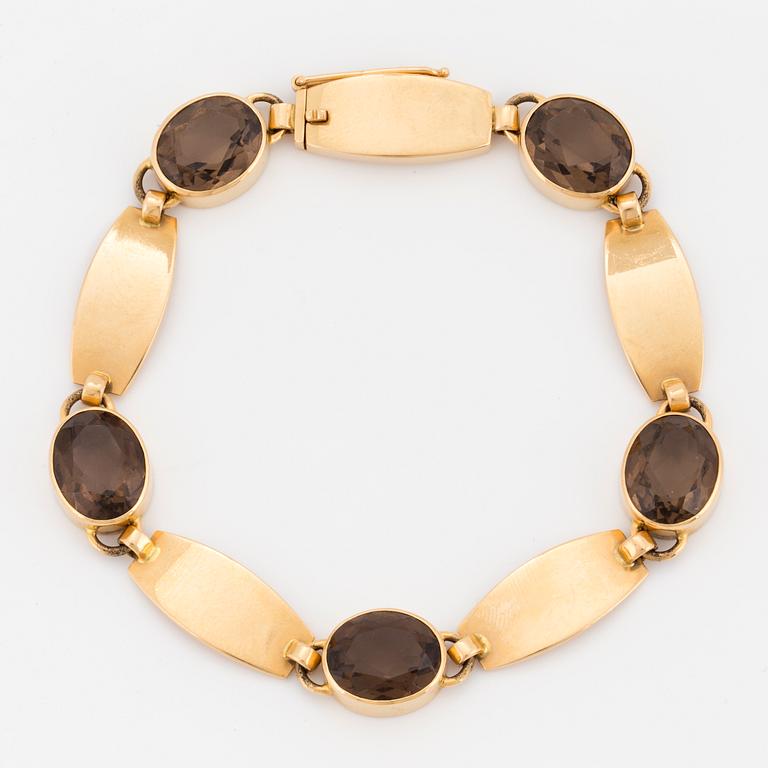 A Just Andersen 18K gold and smoky quartz bracelet.