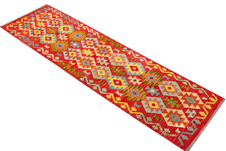 An Afghan kilim runner, c. 301 x 83 cm.