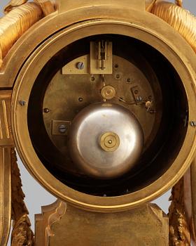 A Louis XVI-style late 19th Century gilt bronze mantel clock.