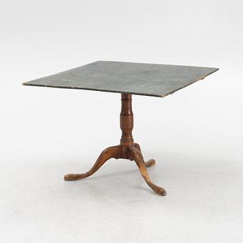 A root veneered tilt-top table, 19th Century.