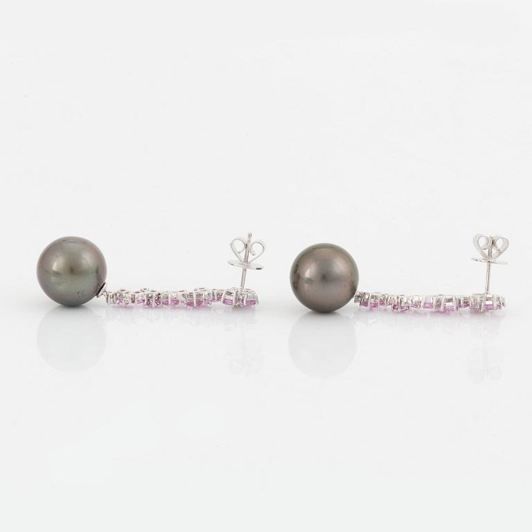 A pair of 18K white gold earrings set with Tahitian cultured pearls and round brilliant-cut diamonds.