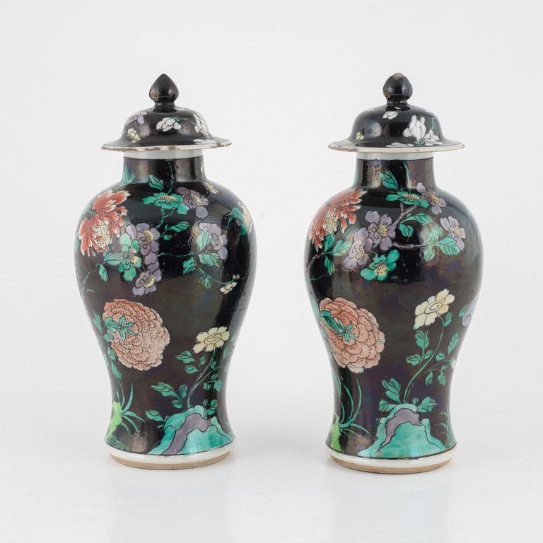 A pair of Famille Noir lidded urns, China, 20th century.
