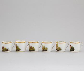 A group of seven cups, one with dish, Germany and France, 19th century.