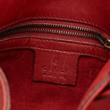 GUCCI, a red leather crossbody bag.