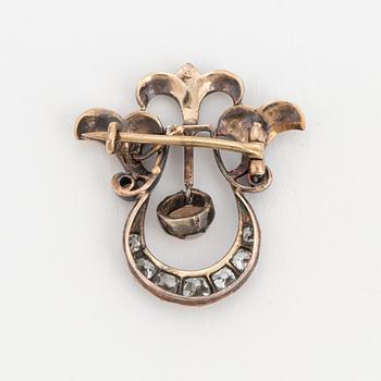 A brooch set with a mabé pearl and old-cut diamonds.