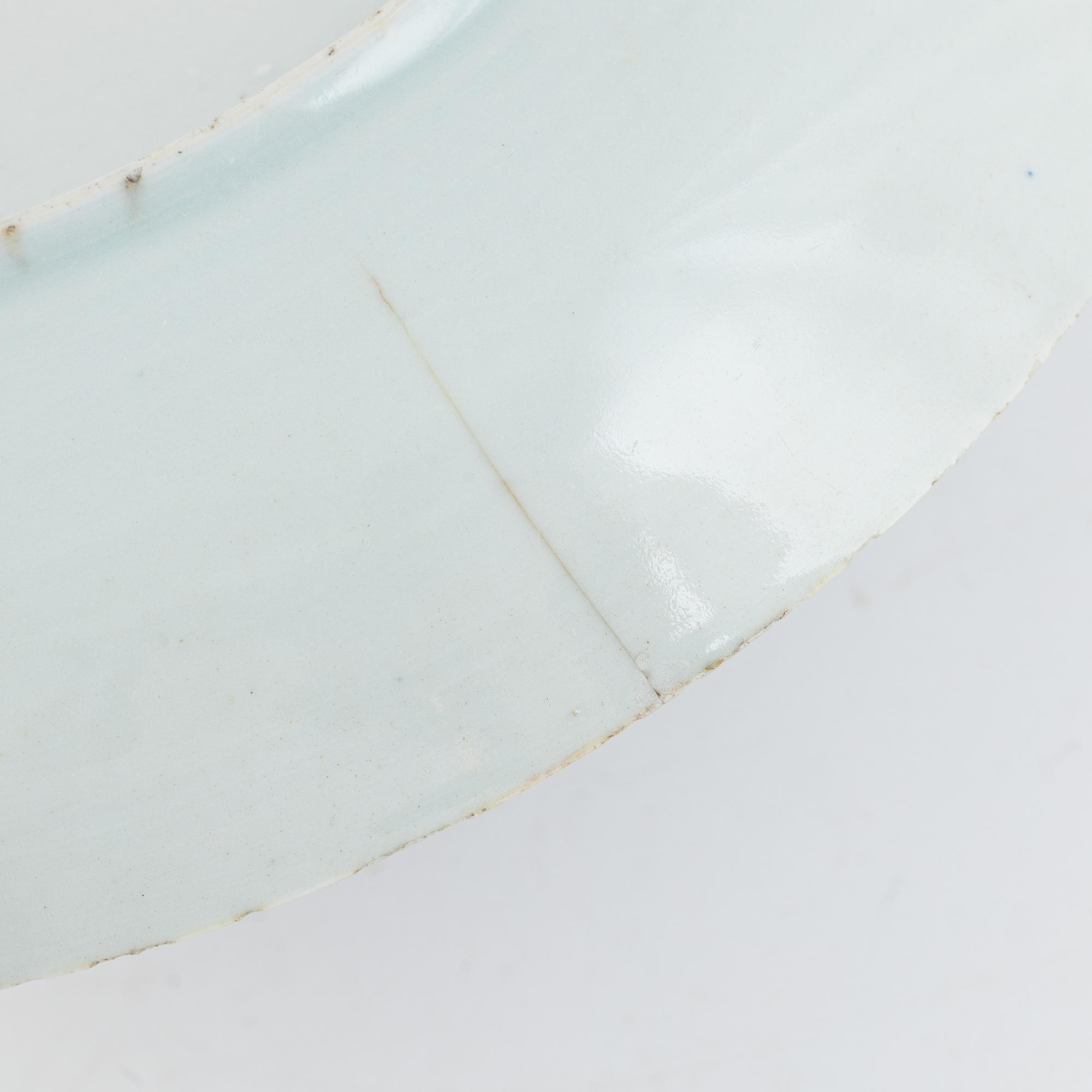 A pair of blue and white Chinese porcelain plates and a deep serving dish, Qing dynasty, 18th century.