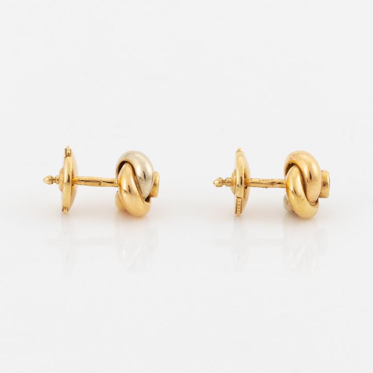 A pair of 18K gold Cartier "Trinity" earrings set with round brilliant-cut diamonds.